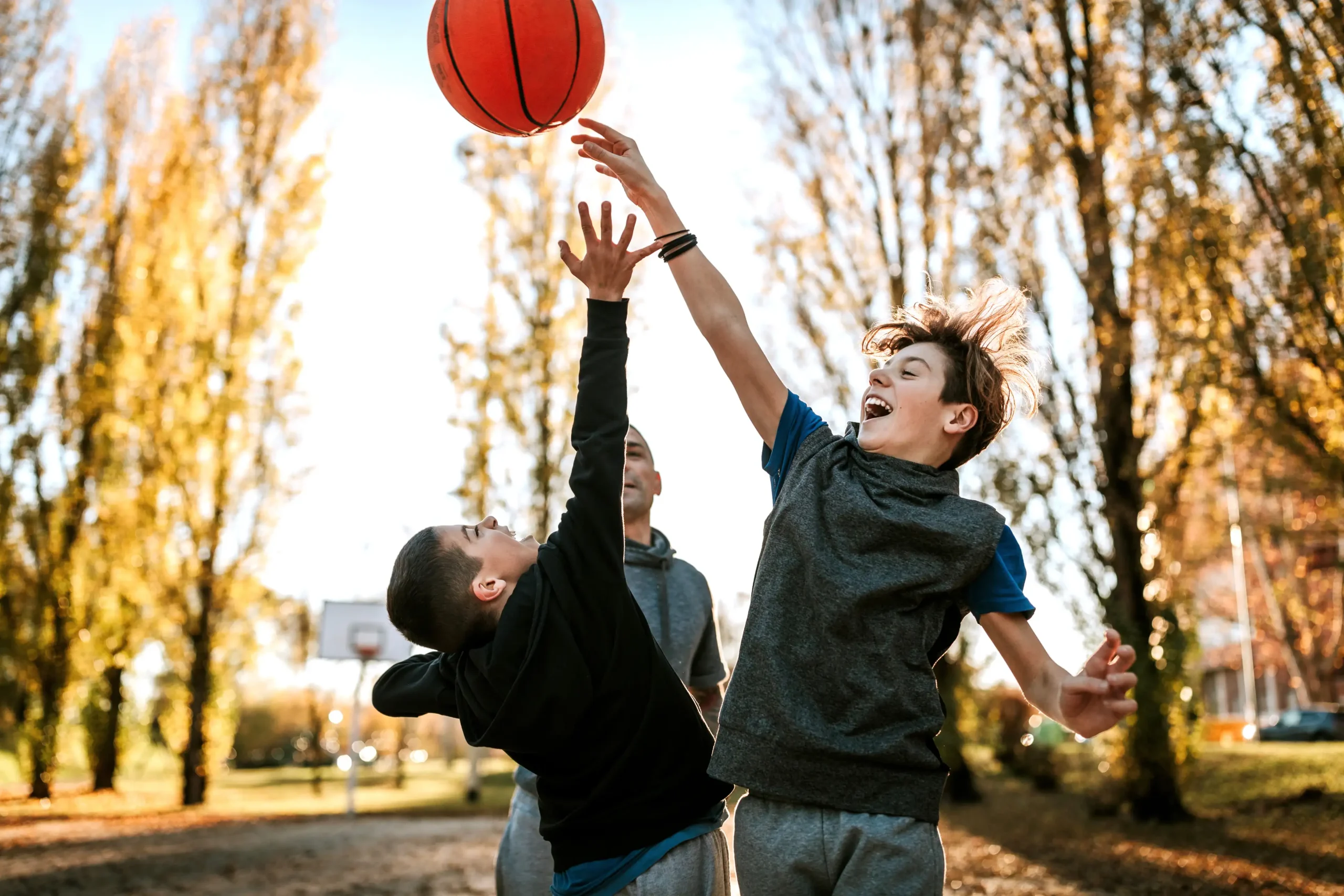 two boys playing basketball